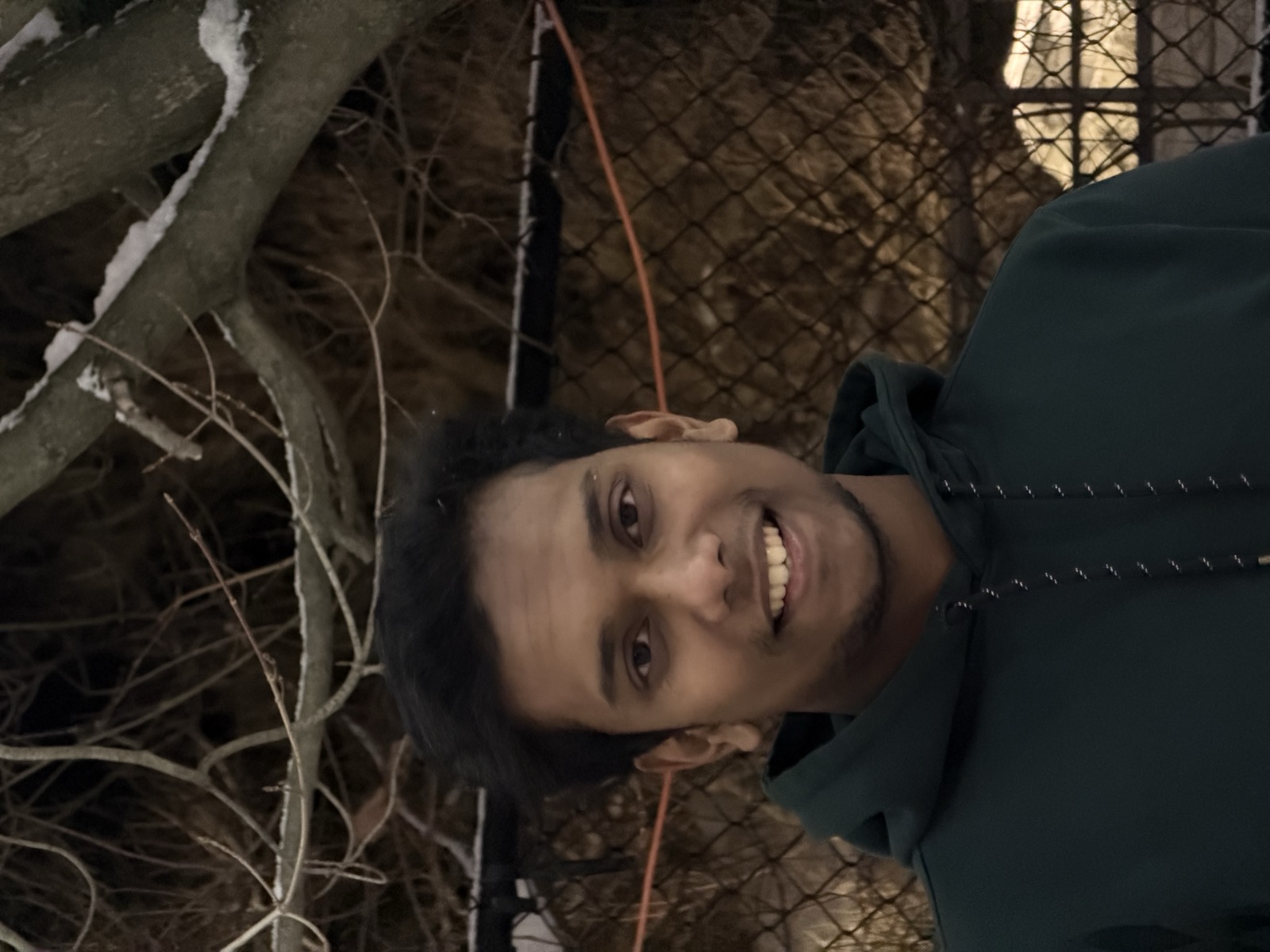 Sonu outdoors in a green hoodie